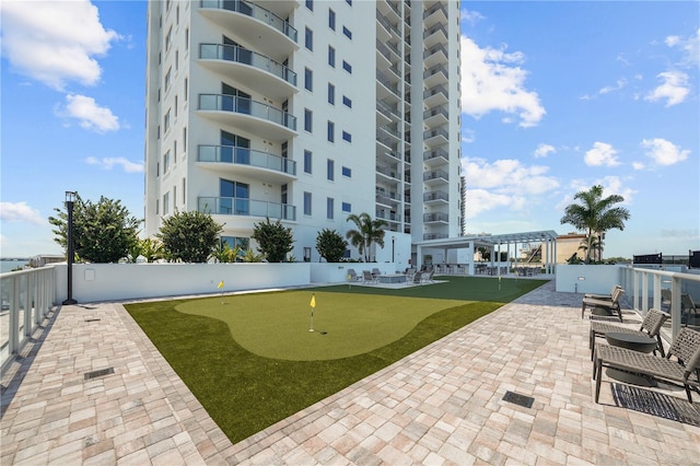 view of property's community featuring a patio area and a pergola