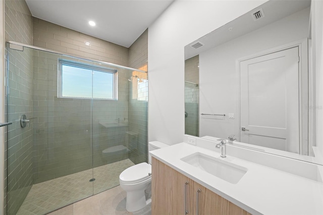 bathroom featuring toilet, vanity, visible vents, a shower stall, and tile patterned floors