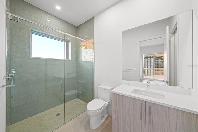 bathroom with toilet, recessed lighting, vanity, a shower stall, and tile patterned floors