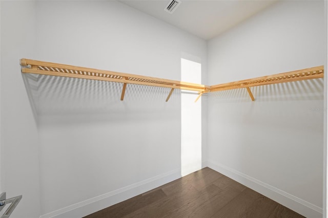 walk in closet featuring dark wood-type flooring and visible vents