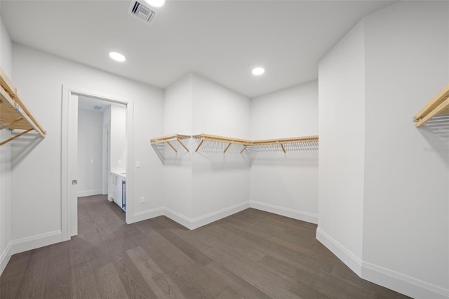 walk in closet featuring dark wood-style floors and visible vents