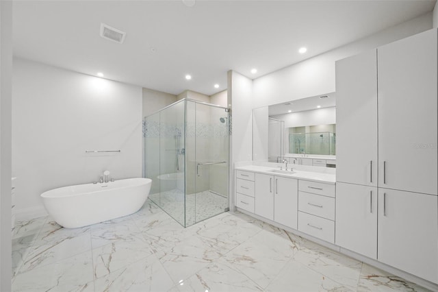 full bathroom featuring a stall shower, visible vents, vanity, a freestanding tub, and recessed lighting