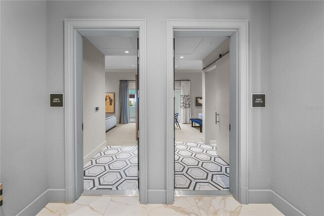 corridor featuring attic access, recessed lighting, marble finish floor, and baseboards