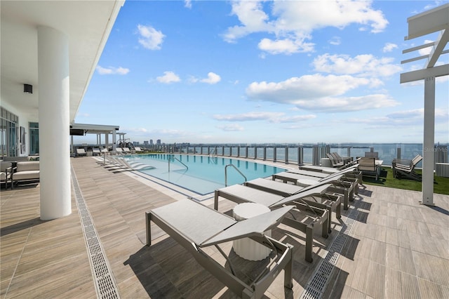 pool with a water view and a patio