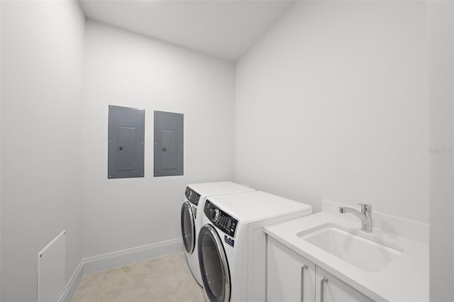 clothes washing area featuring cabinet space, independent washer and dryer, electric panel, and a sink