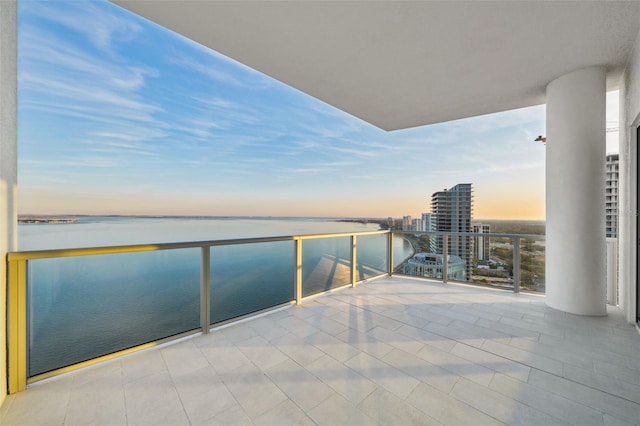 balcony with a water view and a city view