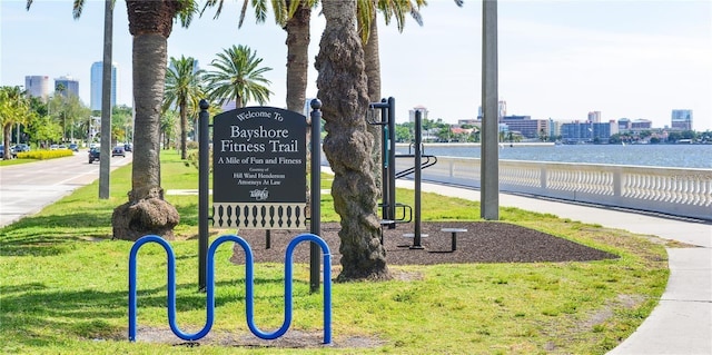 exterior space featuring a lawn and a city view