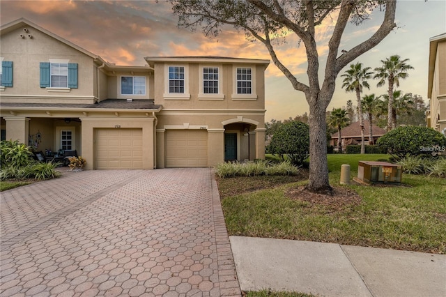 view of front of property featuring a yard and a garage