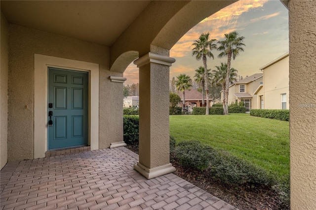 exterior entry at dusk with a yard