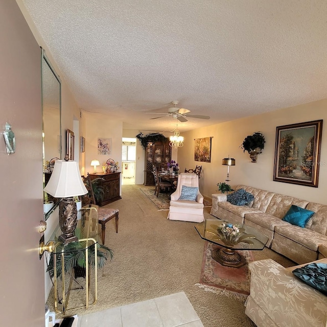 carpeted living room with ceiling fan and a textured ceiling