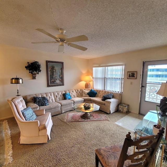 carpeted living room with ceiling fan and a textured ceiling