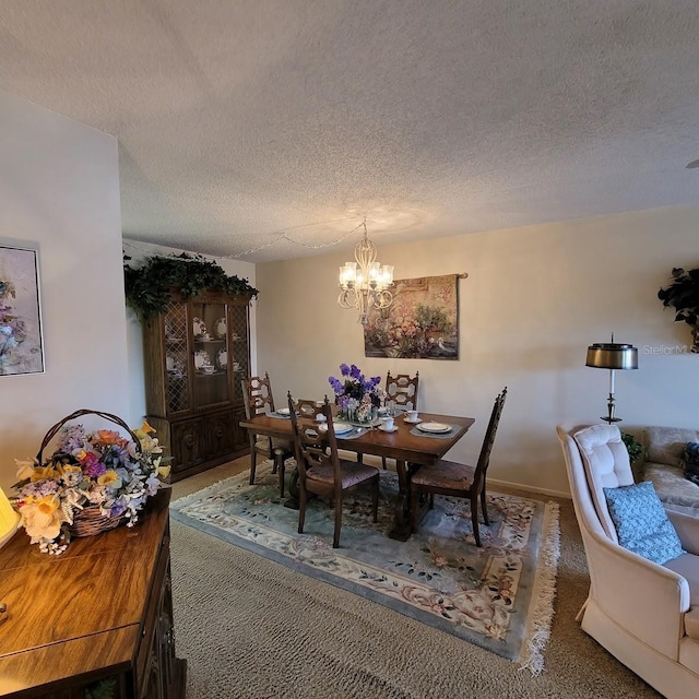 dining area with a notable chandelier and a textured ceiling