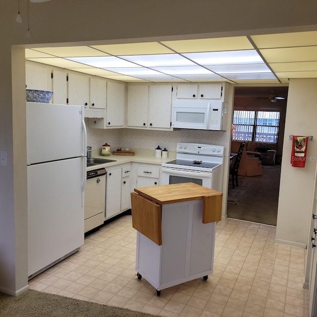 kitchen with white cabinets, white appliances, and sink