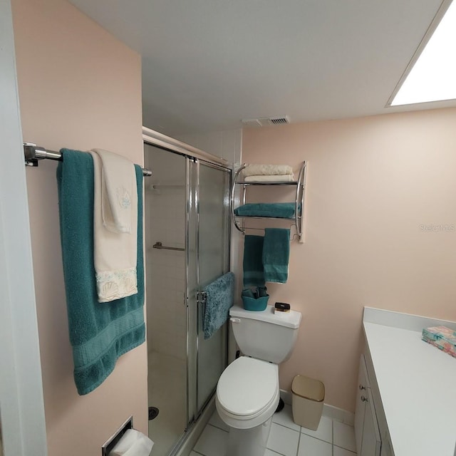 bathroom with toilet, tile patterned flooring, an enclosed shower, and vanity