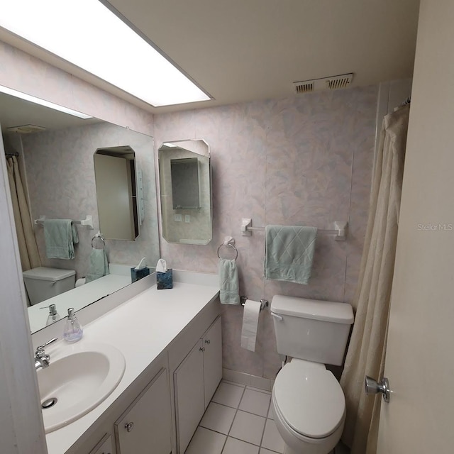 bathroom with vanity, toilet, and tile patterned floors