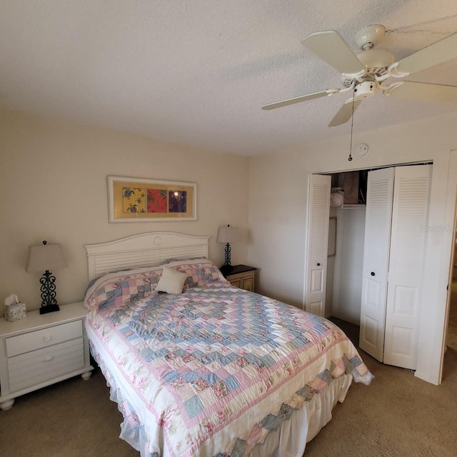 carpeted bedroom with a textured ceiling, a closet, and ceiling fan