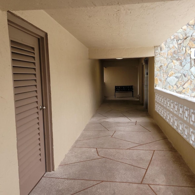 corridor with a textured ceiling