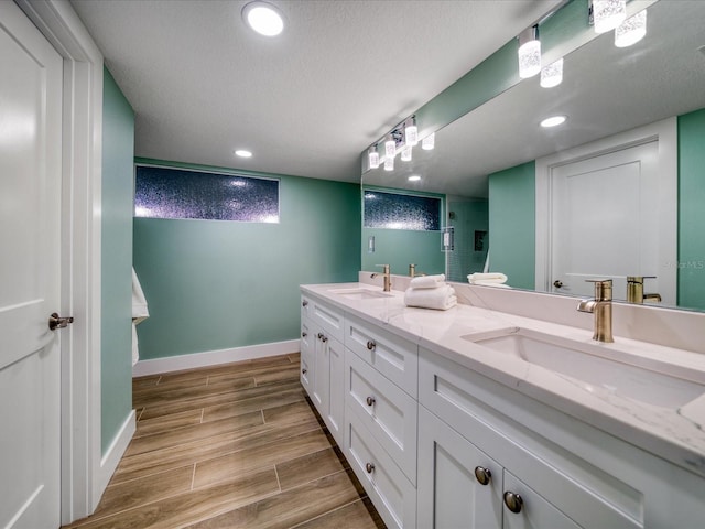 bathroom featuring a textured ceiling and vanity