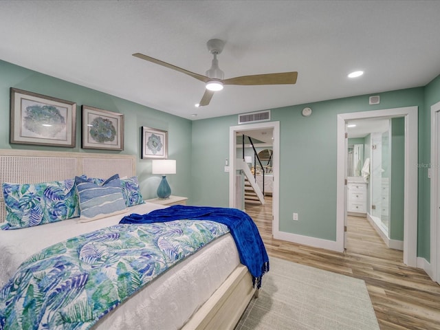 bedroom featuring ceiling fan, connected bathroom, a closet, and light wood-type flooring