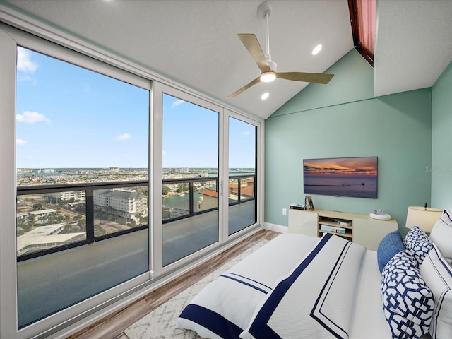 bedroom with ceiling fan, vaulted ceiling, and light hardwood / wood-style floors