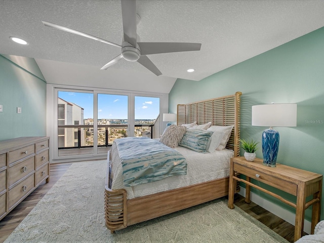 bedroom with ceiling fan, access to exterior, a textured ceiling, and lofted ceiling