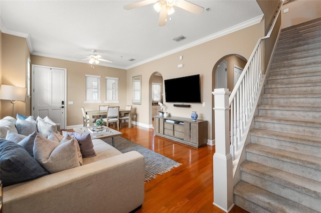 living room featuring crown molding, ceiling fan, and hardwood / wood-style floors