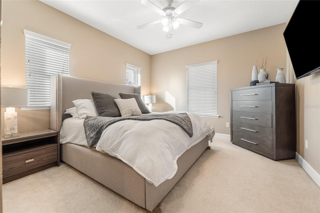 bedroom featuring light carpet and ceiling fan