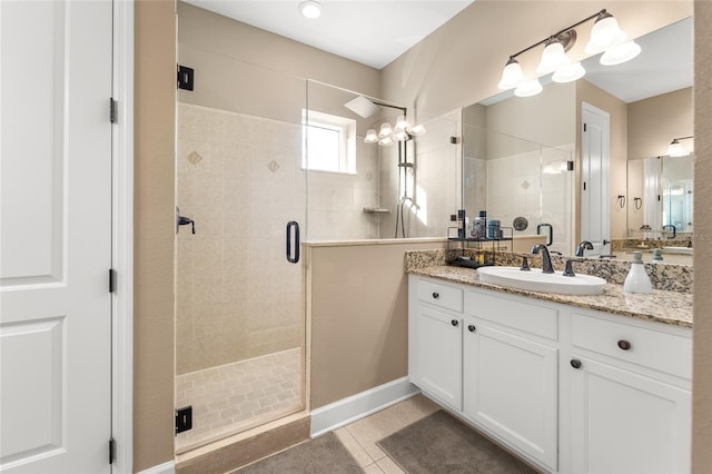 bathroom with tile patterned flooring, vanity, and a shower with door