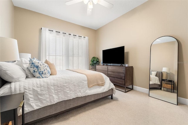 carpeted bedroom with vaulted ceiling and ceiling fan