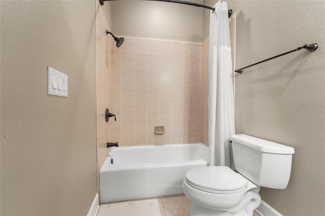 bathroom featuring shower / tub combo with curtain, tile patterned flooring, and toilet