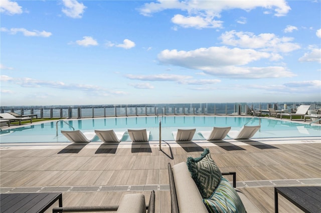 view of pool featuring a water view