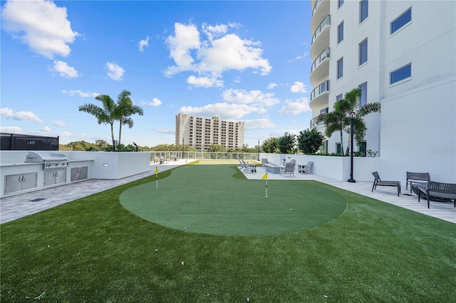 view of property's community featuring exterior kitchen and a patio