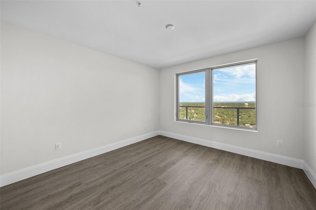 spare room with dark hardwood / wood-style flooring