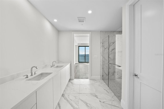 bathroom featuring vanity and a shower with door