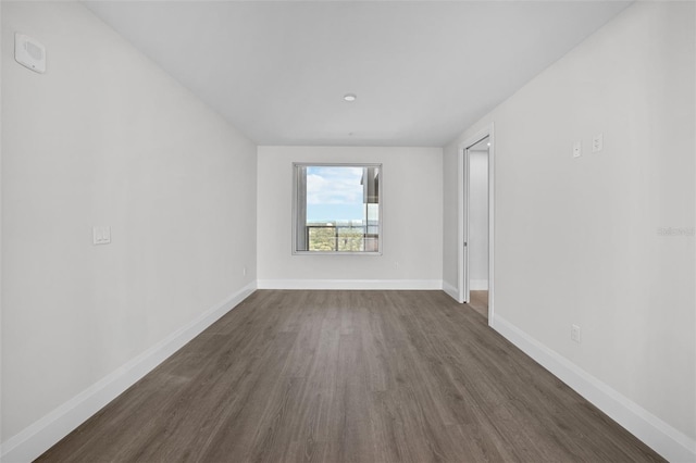 empty room with dark wood-type flooring