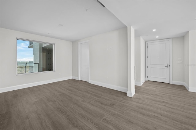 spare room with hardwood / wood-style flooring