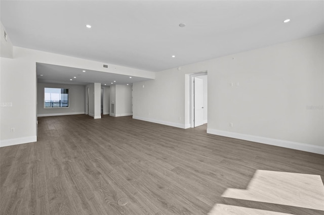 unfurnished living room featuring wood-type flooring