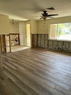 empty room featuring dark wood-type flooring and ceiling fan