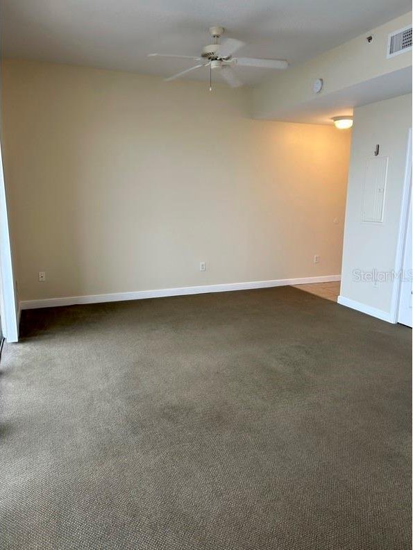 carpeted empty room with ceiling fan