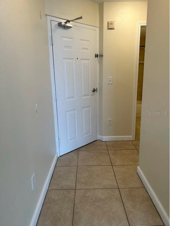 hallway with light tile patterned flooring