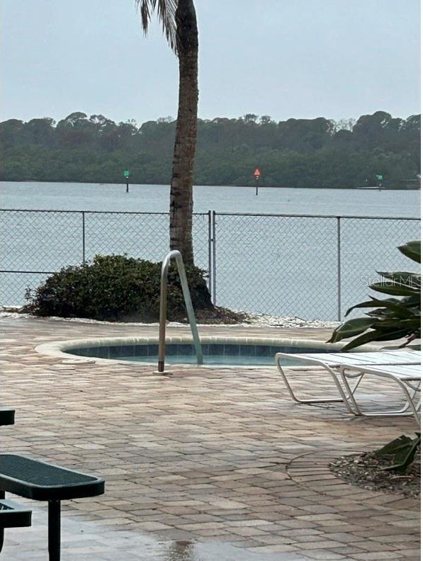 view of pool with a water view