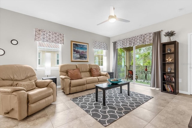 living room with ceiling fan, light tile patterned floors, and a wealth of natural light