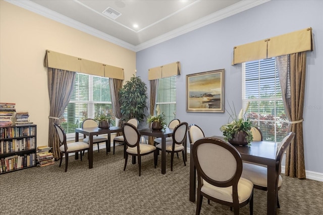 dining area with a wealth of natural light, carpet flooring, and crown molding