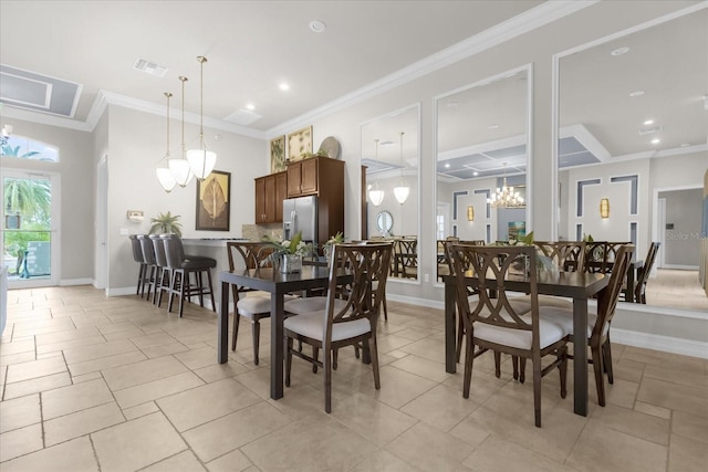 tiled dining area with crown molding and an inviting chandelier