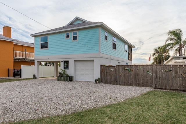 rear view of house featuring a garage