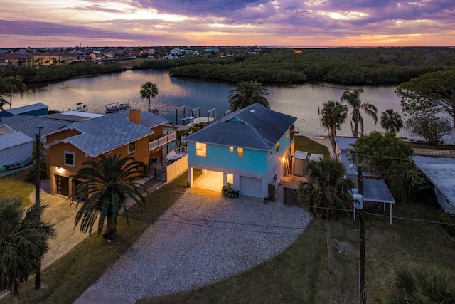 aerial view at dusk with a water view