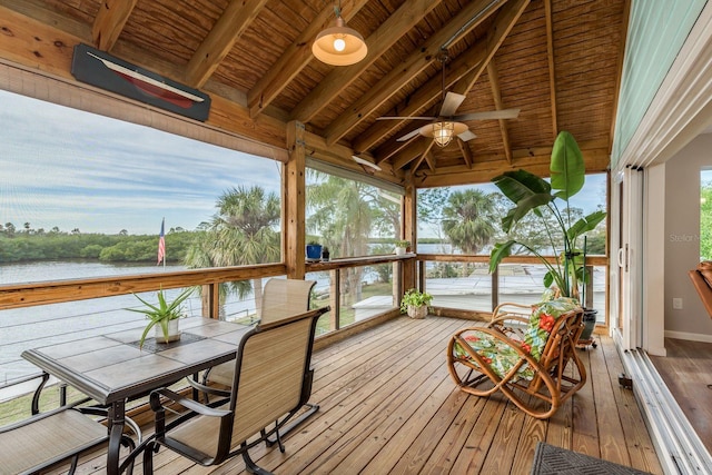 sunroom featuring a water view, ceiling fan, wood ceiling, and vaulted ceiling with beams