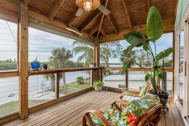 wooden deck with a water view and ceiling fan