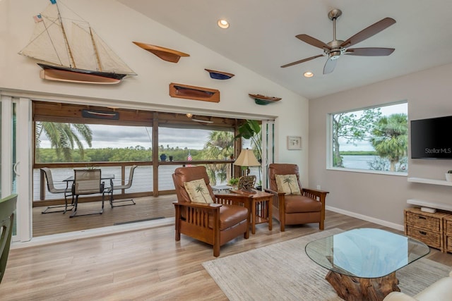 sitting room featuring high vaulted ceiling, ceiling fan, and light wood-type flooring