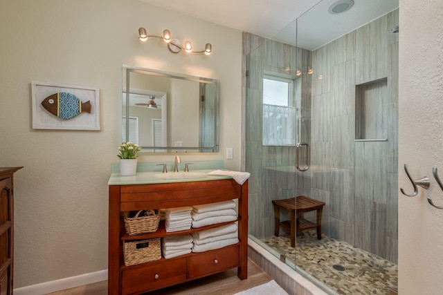 bathroom featuring an enclosed shower, vanity, and hardwood / wood-style floors